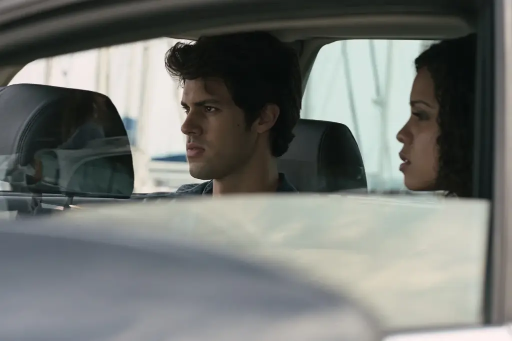 A couple sitting in a parked car at a Fort Lauderdale marina, he looks ahead while she looks at him