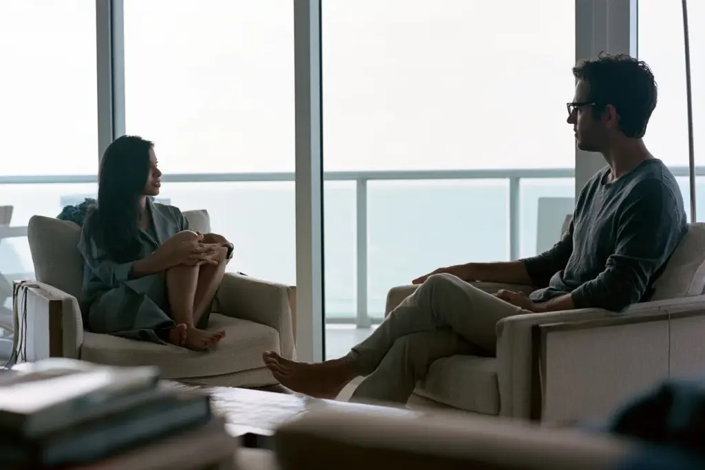 A couple in calm conversation in a modern coastal living room in South Florida